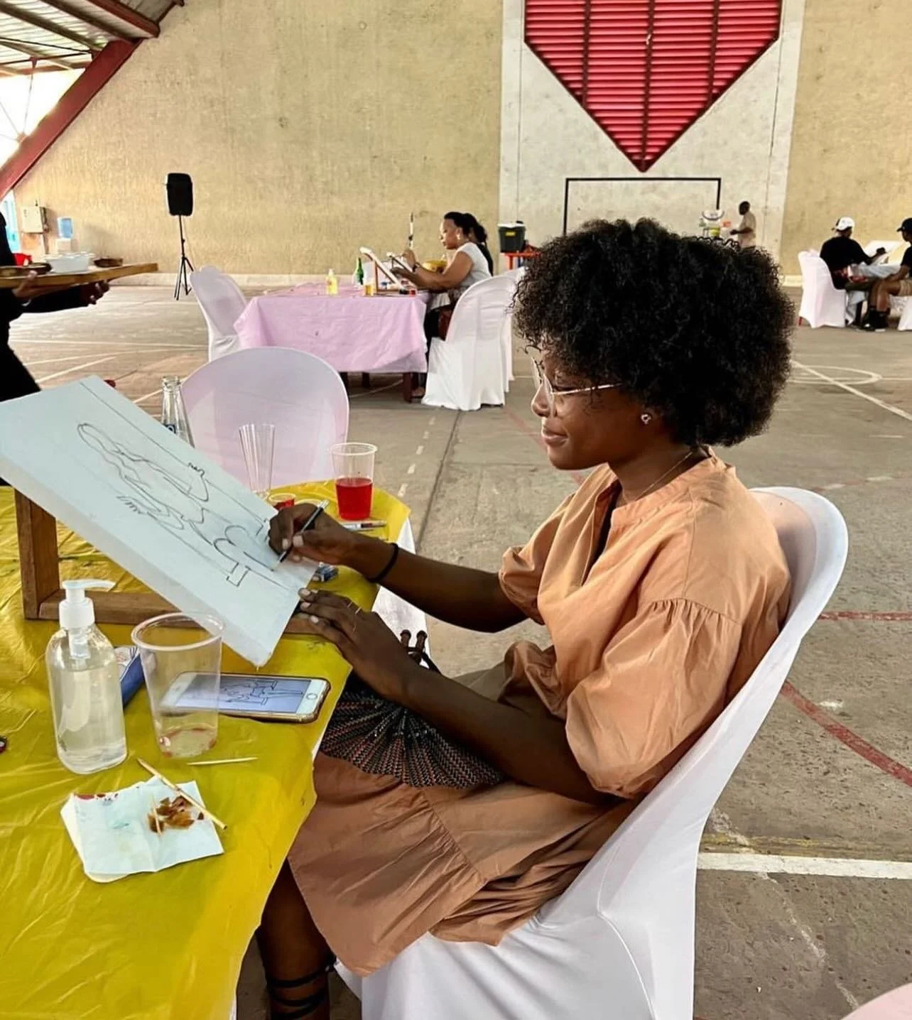 Guest sketching her canvas at a Kongo social