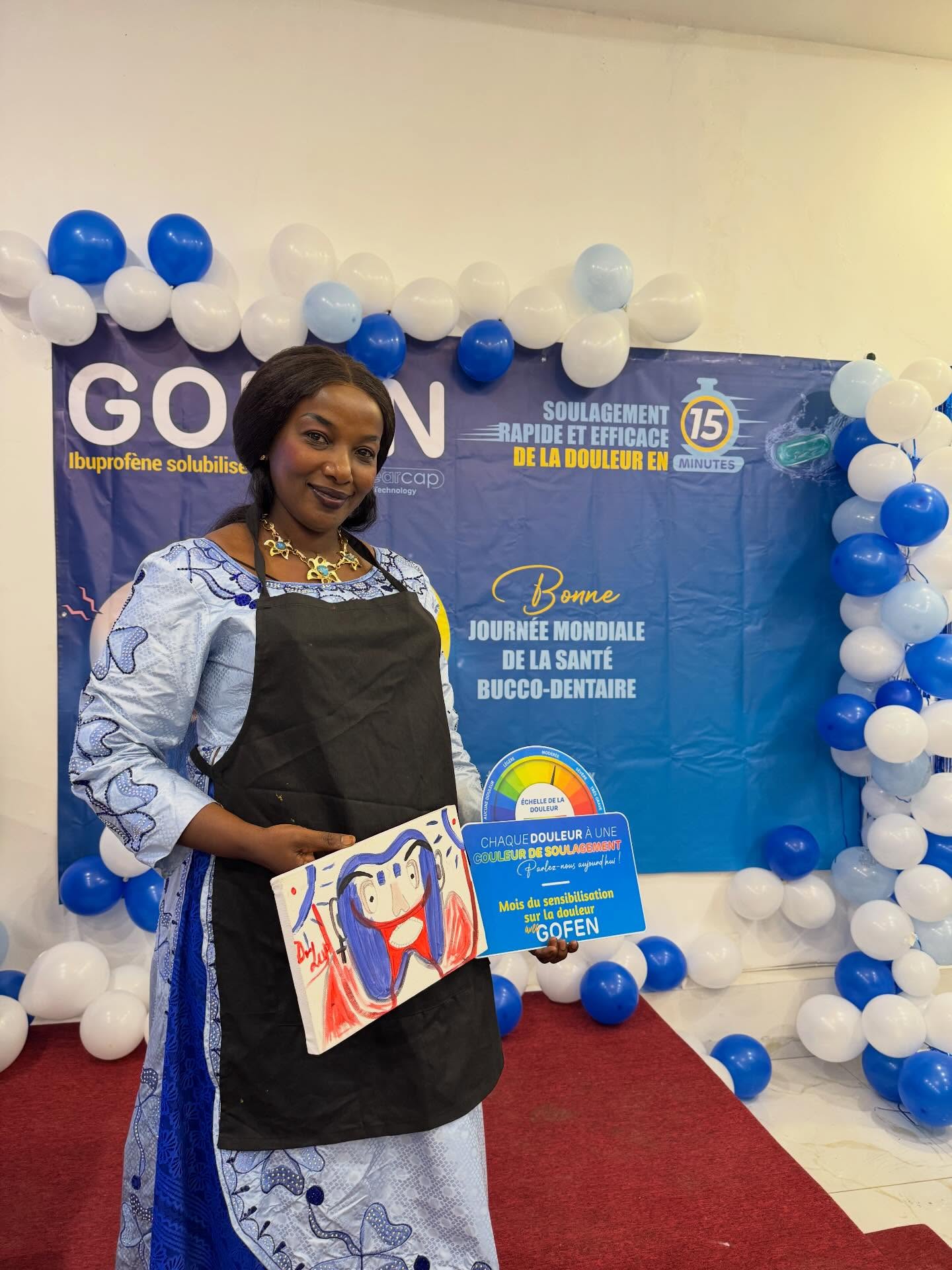 Guest proudly holding her painting at a brand activation